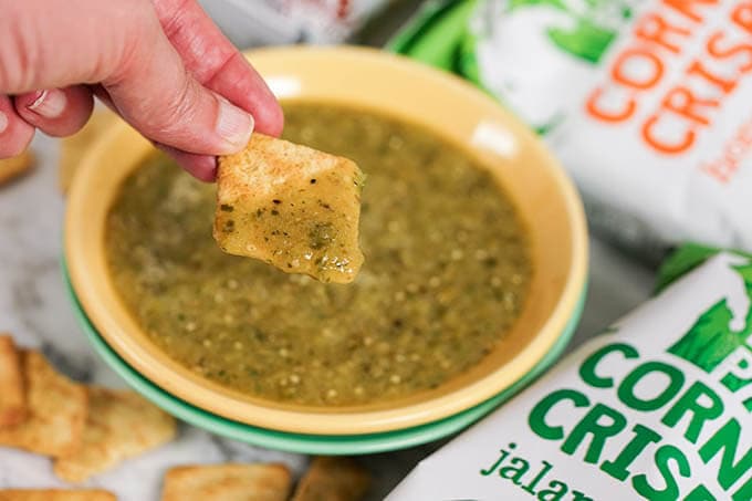 Dipping chips into bowl of Green Salsa Recipe