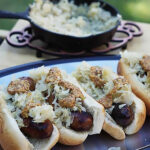 Beer Brats topped with sauerkraut and mustard.