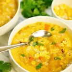 Vegetarian Corn Chowder in bowl with serving spoon.