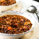 Two bowls of the BEST Bean soup in white bowls with spoon.