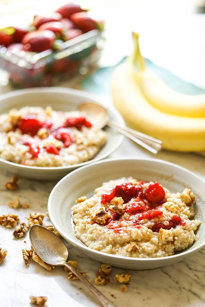 Instant Pot Steel Cut Oats in gray bowl with strawberries.