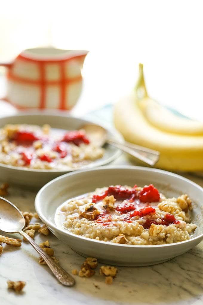 Instant Pot Steel Cut Oats in bowls with strawberries and milk.