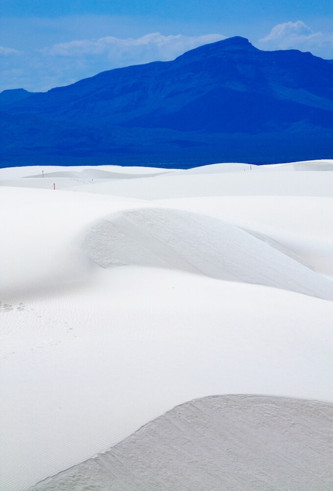 Mountains of white sands against the blue mountains - White Sands New Mexico National Monument