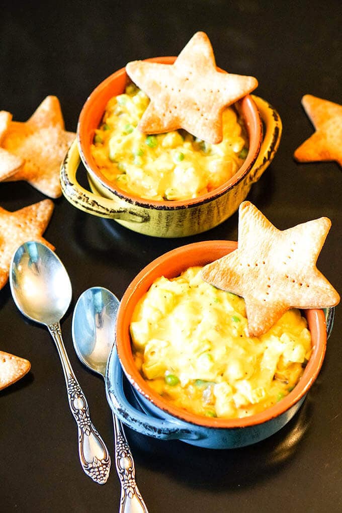 Two bowls filled with Easy Chicken Pot Pie Soup, topped with crackers