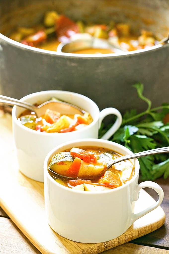Fresh Tomato Soup Recipe in white bowls with spoon.
