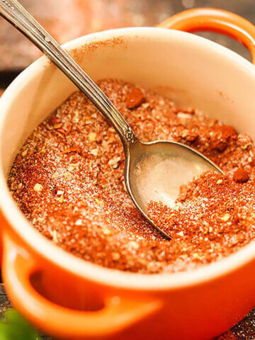 Spice mix in jar with spoon.