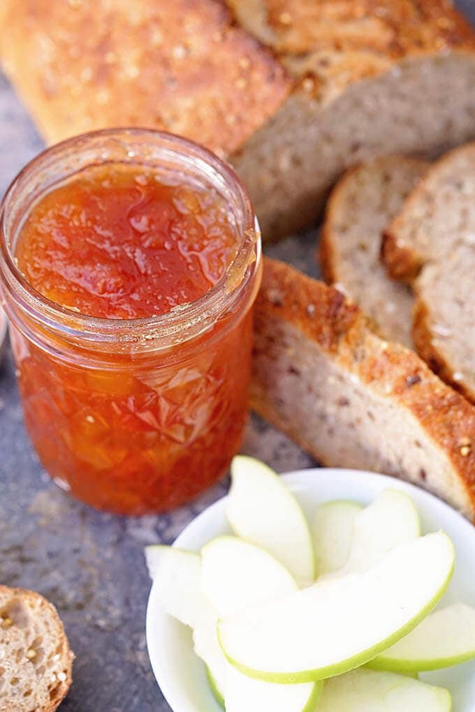Papaya Jam in jar with bread and apple slices