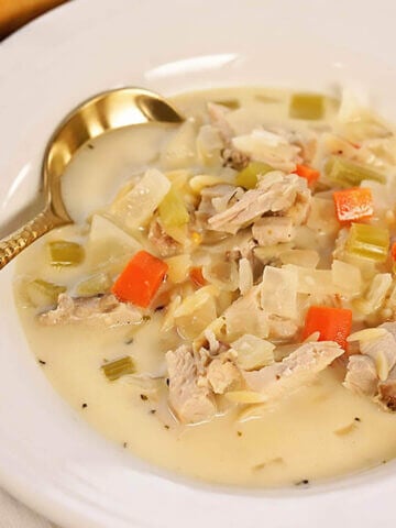 Lemon Chicken Orzo Soup in bowl with spoon.