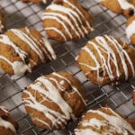 Persimmon cookies on cooling rack drizzled with white chocolate.