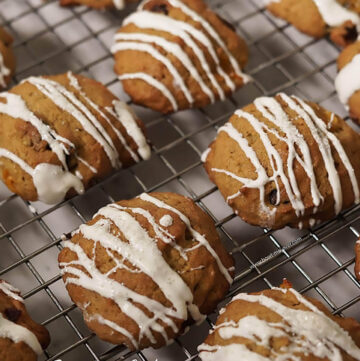 Persimmon cookies on cooling rack drizzled with white chocolate.