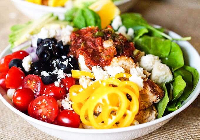 One Chicken Burrito Bowl filled with tomatoes, beans and vegetables.