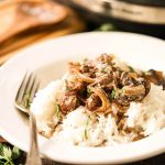 Easy Crock Pot Beef Stroganoff in white bowl with fork.