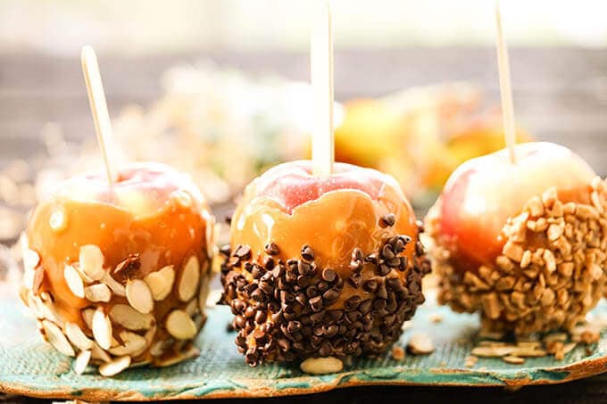 Candy apples on blue platter.