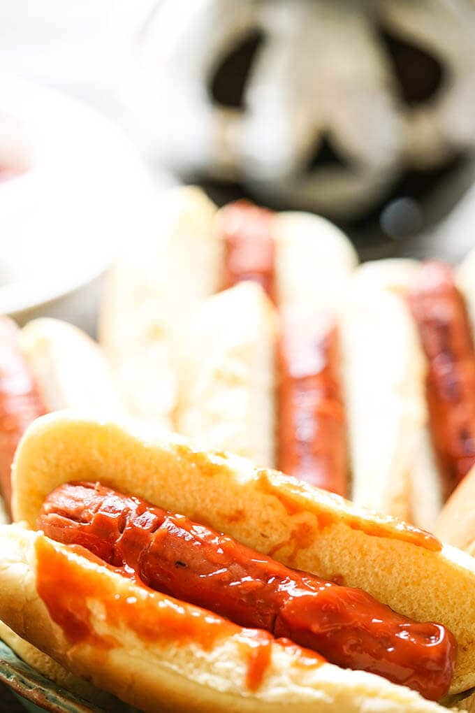 Hotdogs in buns decorated for Halloween