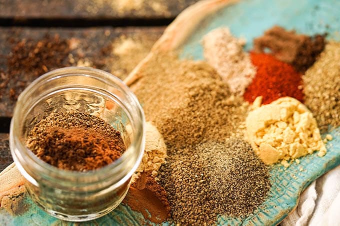 Spices on platter with jar to mix them in.