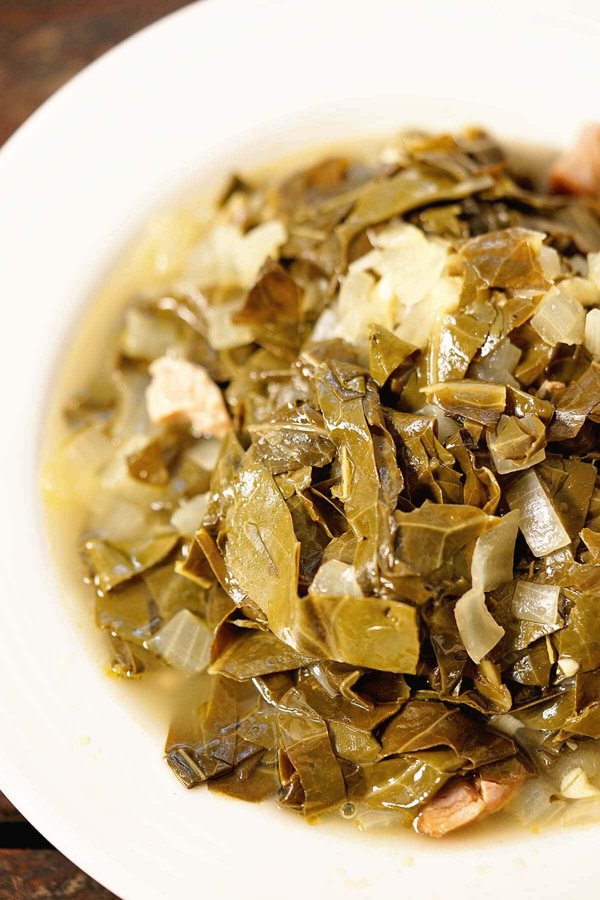 Easy Collard Greens Recipe with Ham Hock in white bowl.