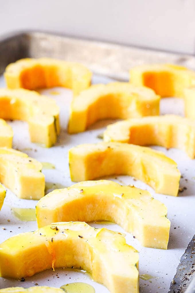 Raw Squash on sheet pan drizzled with olive oil, salt and pepper.