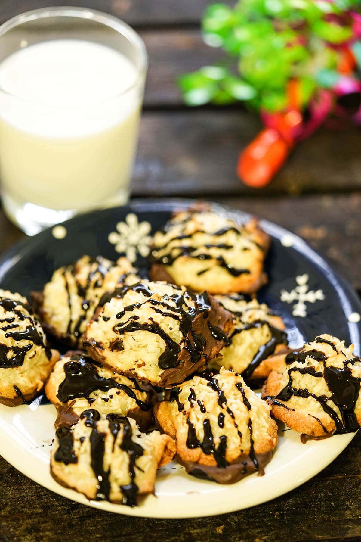 Chocolate Dipped Coconut Macaroons on plate with milk.