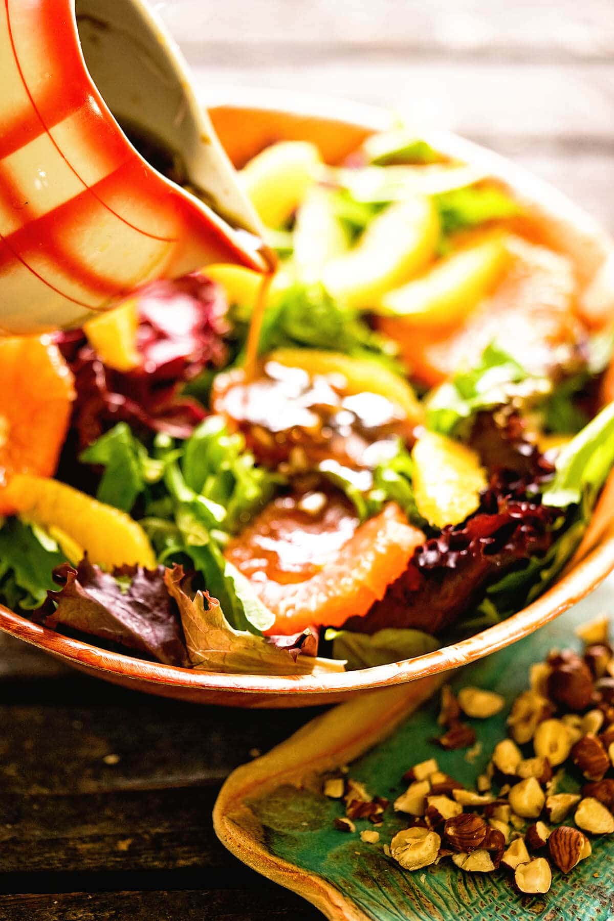 Citrus Salad Recipe topped with orange slices, nuts and homemade salad dressing.