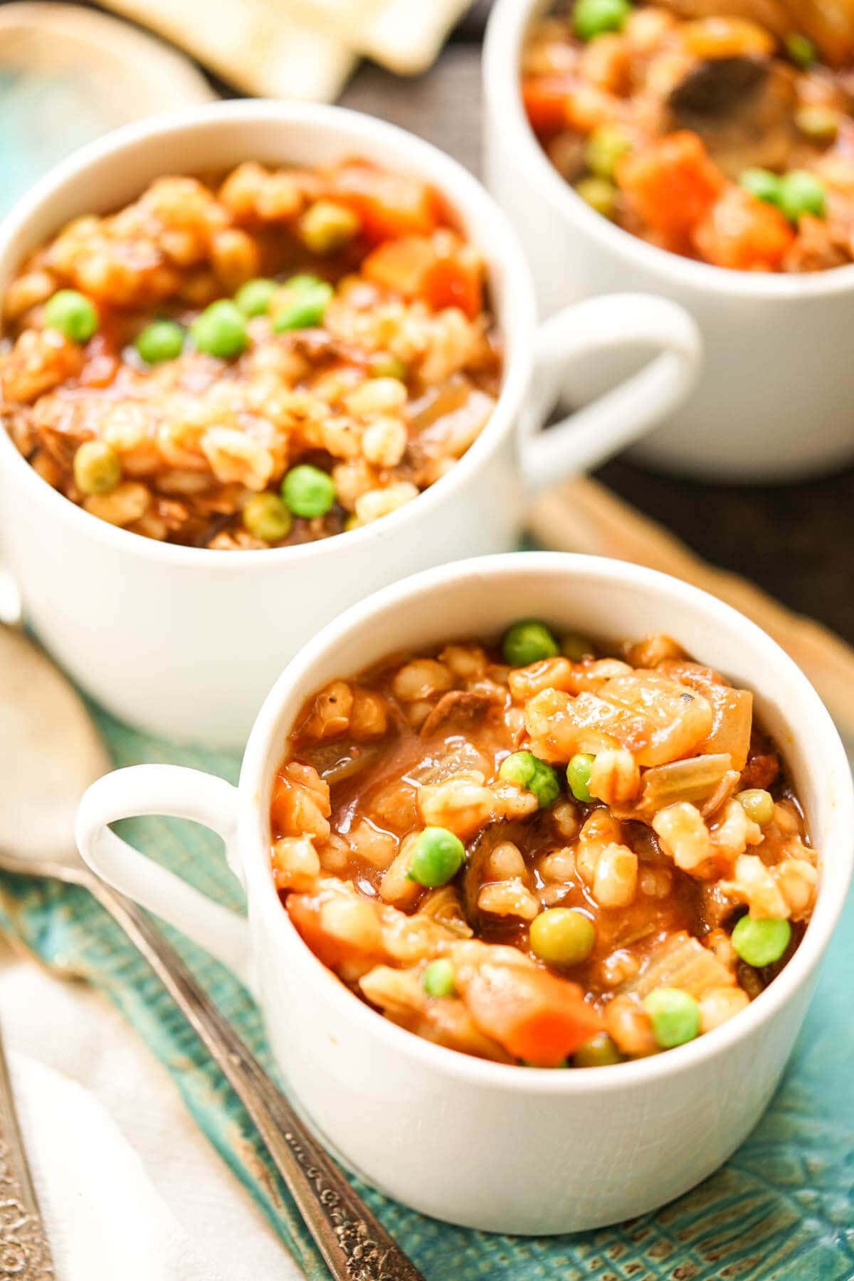 White bowls filled with Instant Pot Beef Barley Soup