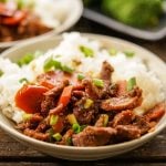 Stir-fried beef with vegetables in bowl with rice.
