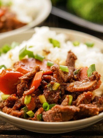 Stir-fried beef with vegetables in bowl with rice.