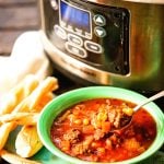 Italian Beef Stew in green bowl served with breadsticks.
