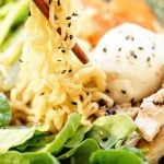 Ramen noodles in a bowl with a poached egg and spinach. Chopsticks are grabbing a big serving of noodles to slurp, with Pinterest overlay.