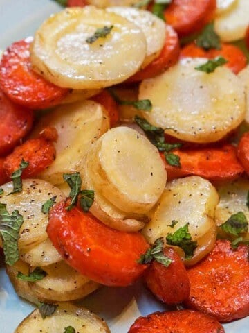 Oven Baked Carrots on platter garnished with mint.
