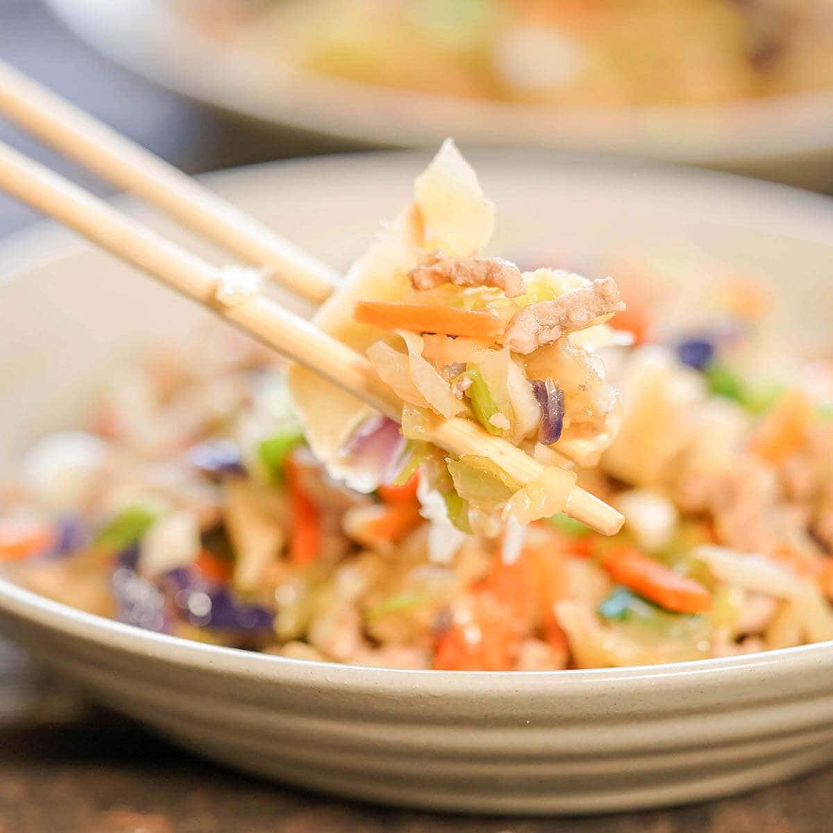 Egg Roll in a bowl with chopsticks.