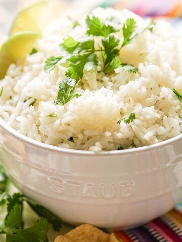 White rice in bowl topped with cilantro.
