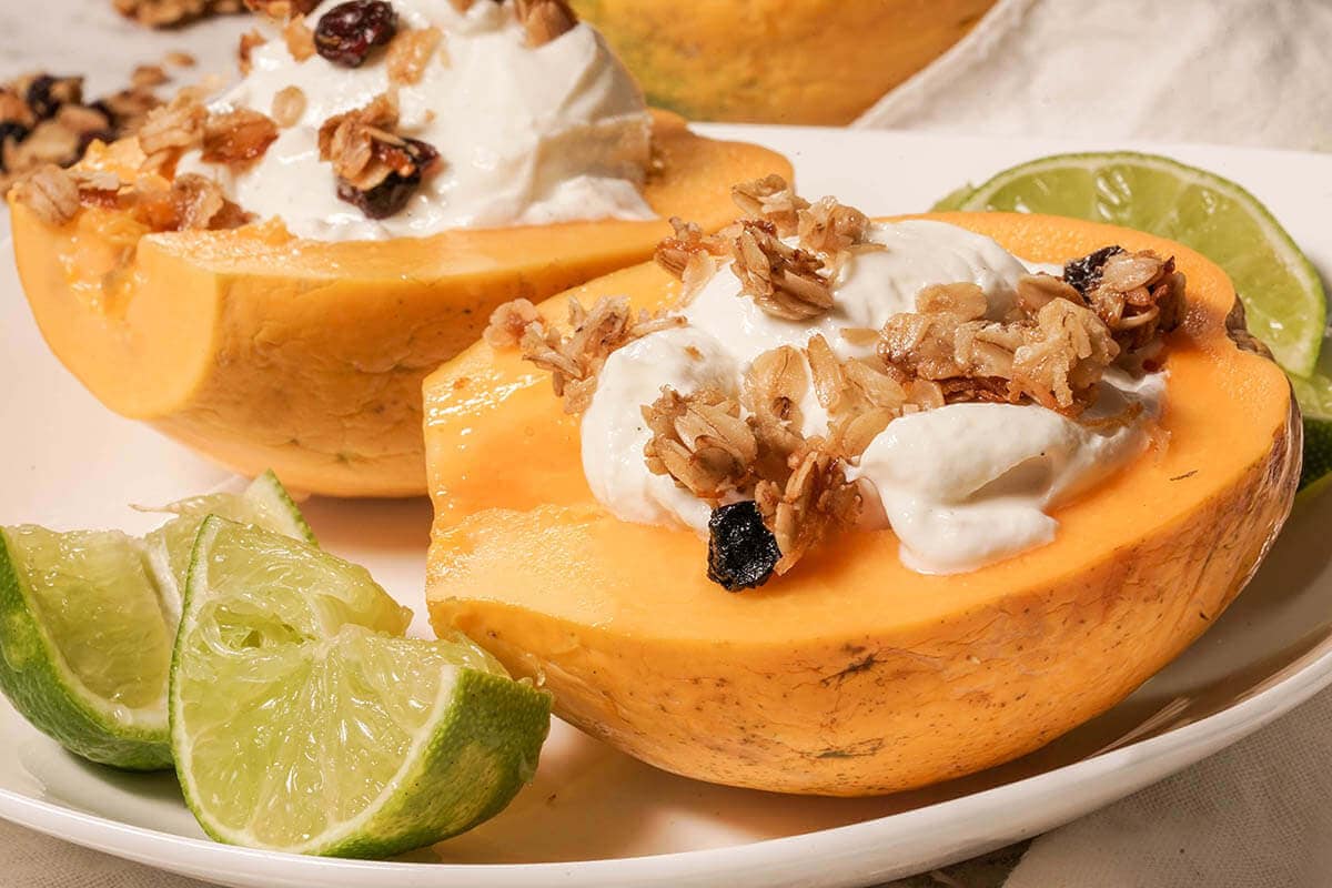 Papaya Breakfast Bowl topped with yogurt and lime.