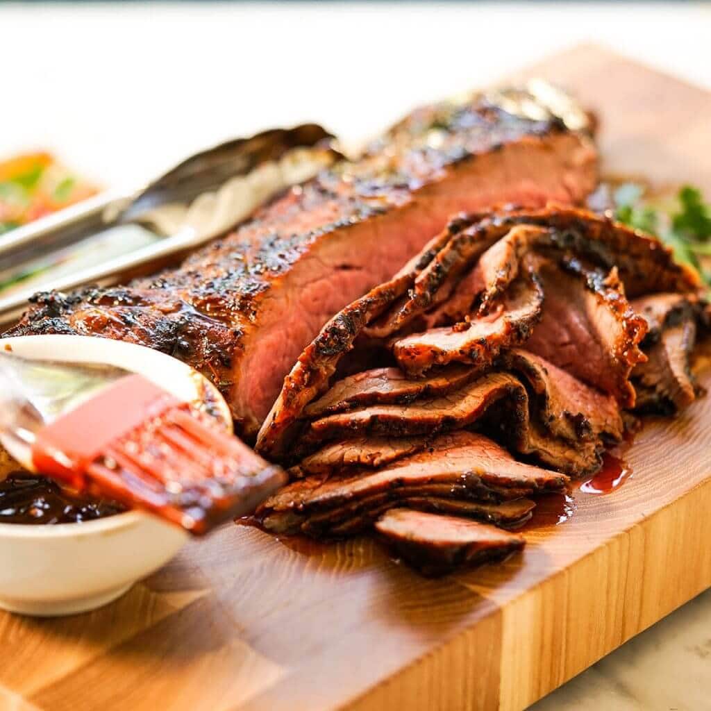 Sliced Grilled Tri Tip on cutting board.