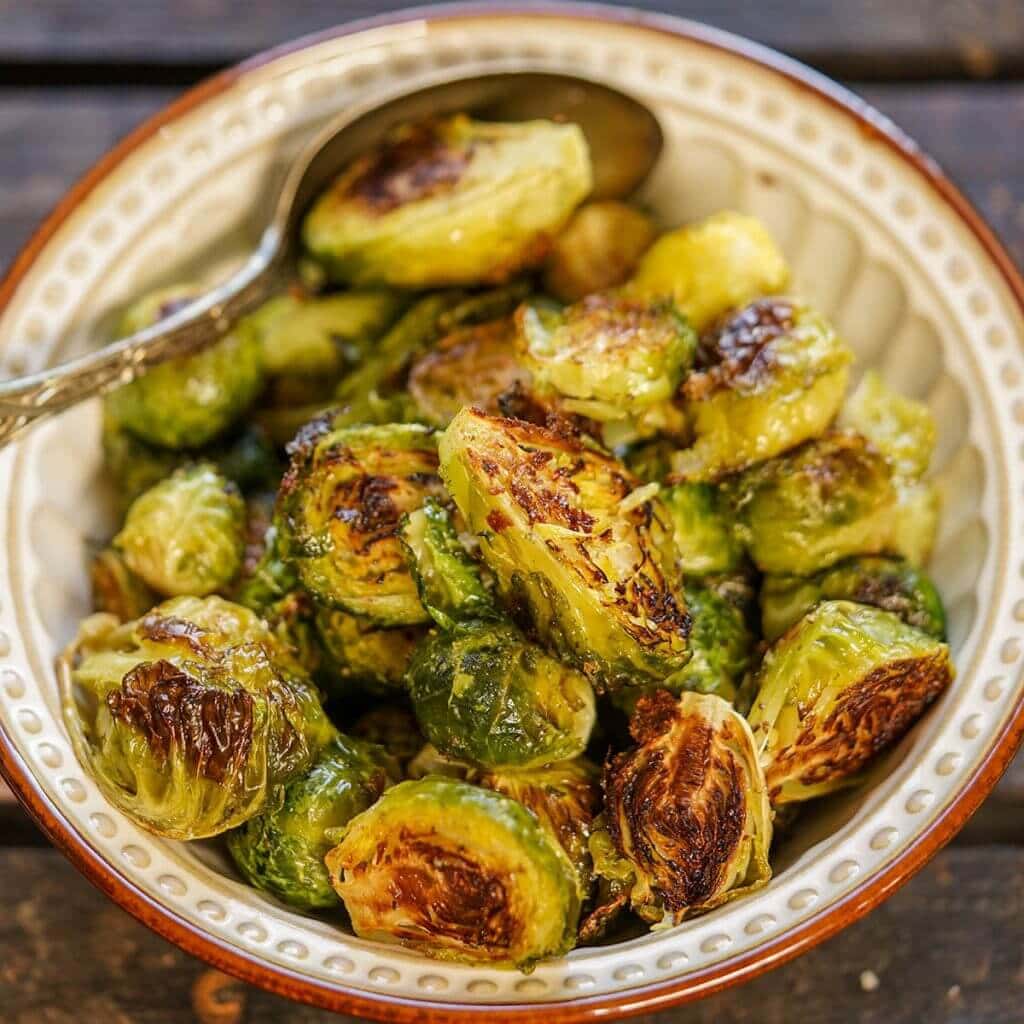 Roasted Brussel Sprouts in bowl with spoon.