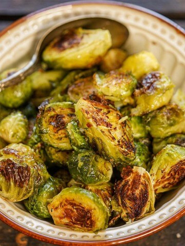Roasted Brussel Sprouts in bowl with spoon.