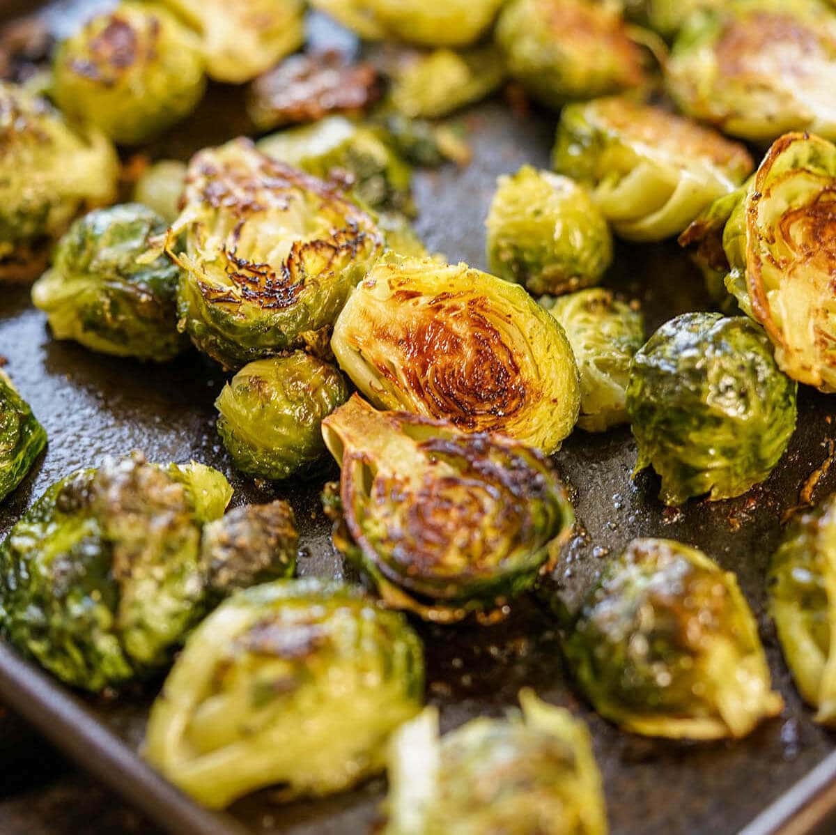 Roasted Brussels sprouts on a sheet pan.