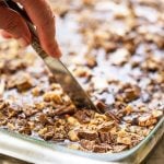 Chocolate Sheet Pan Cake being sliced with knife.