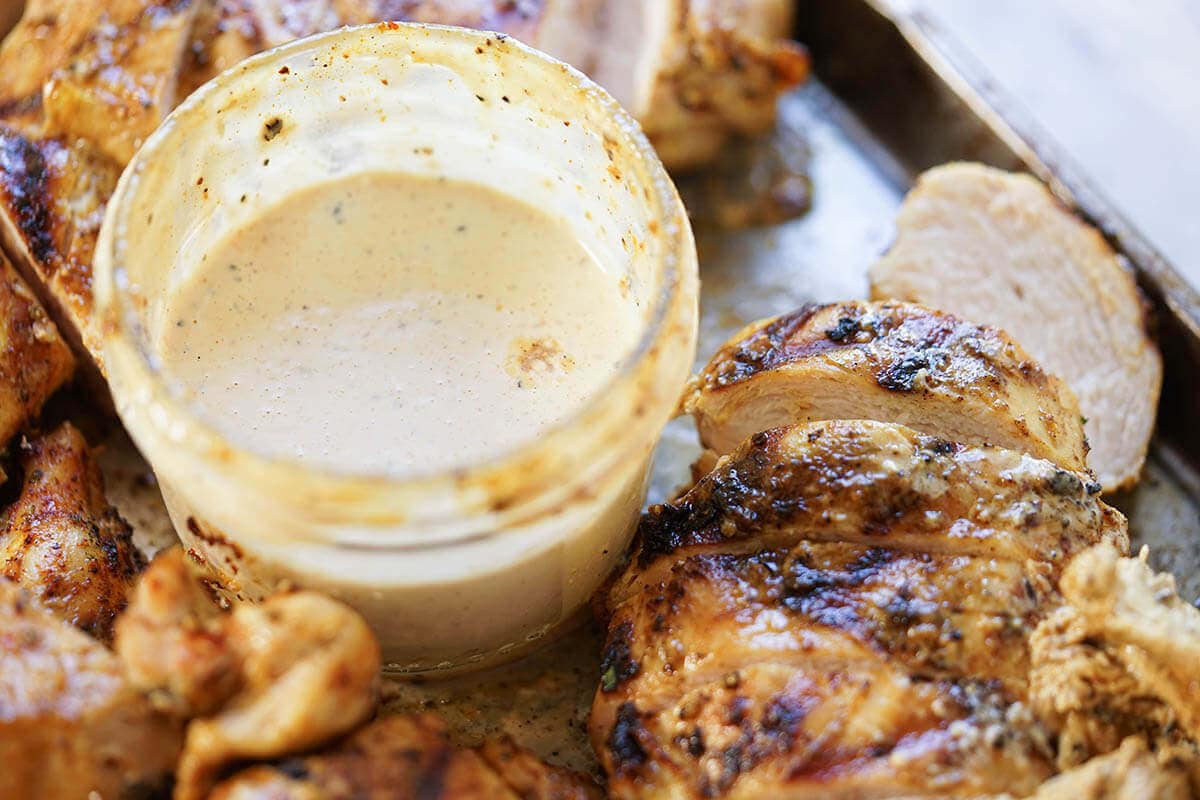 Platter of sliced chicken with dipping sauce. 