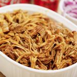 BBQ pulled pork that has been shredded in white bowl.