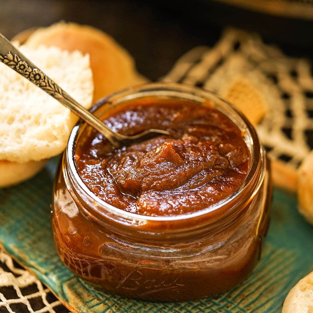 Pumpkin Butter in a small glass jar with spoon. 