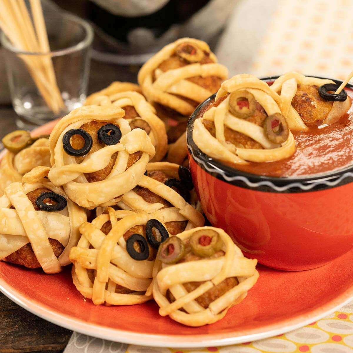 Mummy Meatballs on plate with Marinara Sauce for dipping.