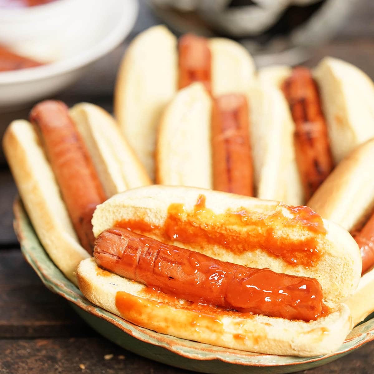 Hot dogs carved to look like finger that are in a bun topped with catsup.