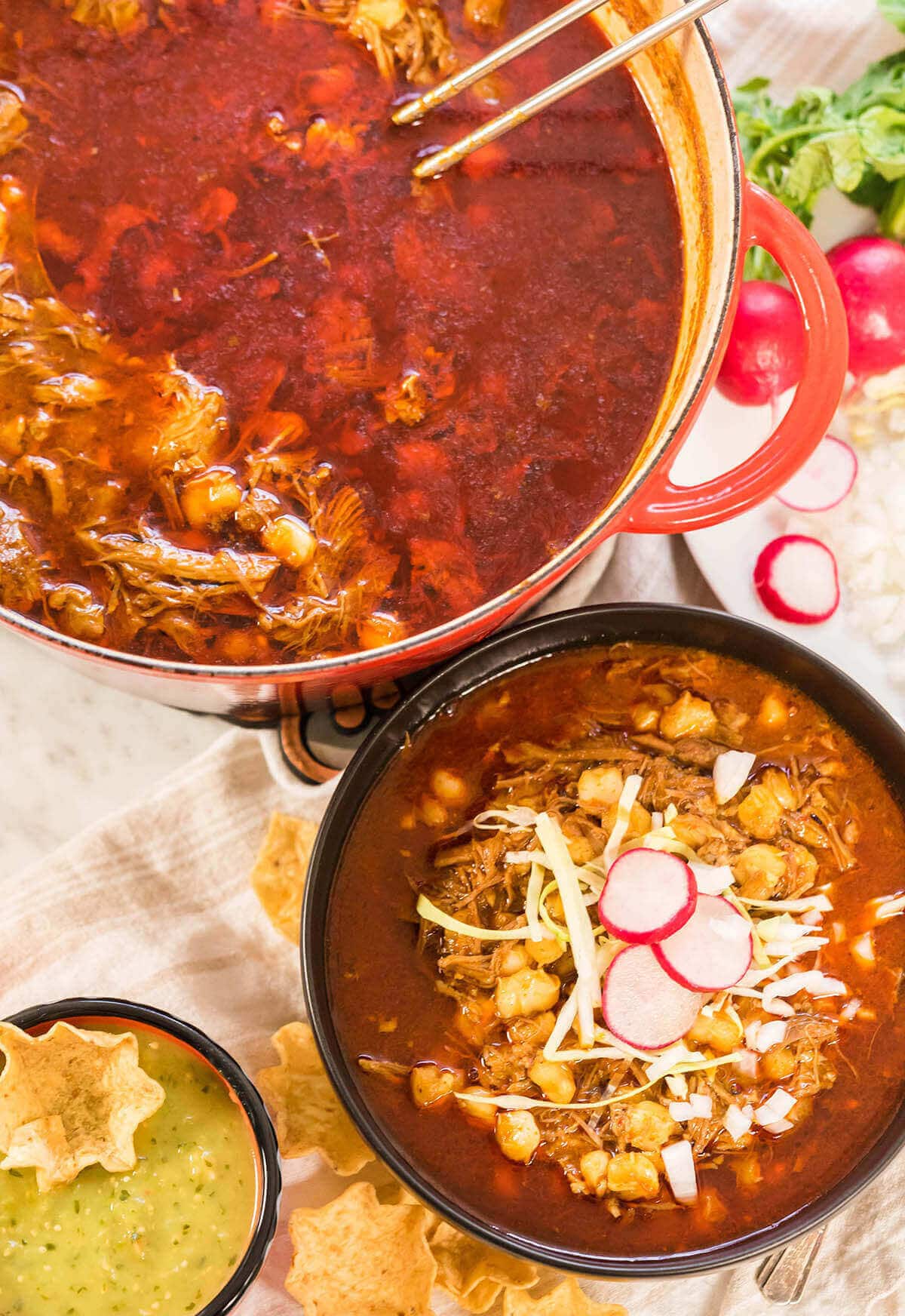 New Mexico Posole Recipe in large pot alongside a bowl filled with pozole.