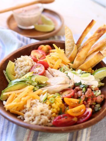 Rotisserie Chicken Burrito Bowl with salad dressing.