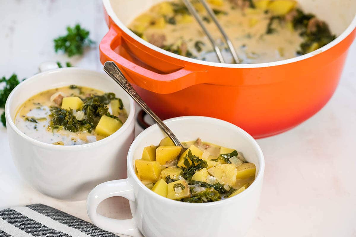 White bowls with Italian Sausage Potato Soup.