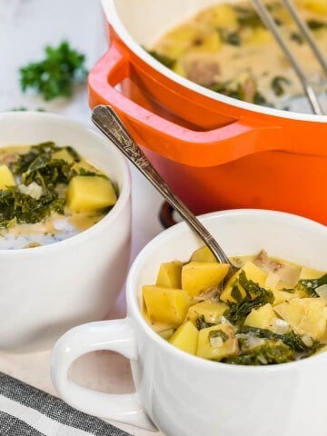 White bowls filled with Zuppa Toscana Soup Recipe.