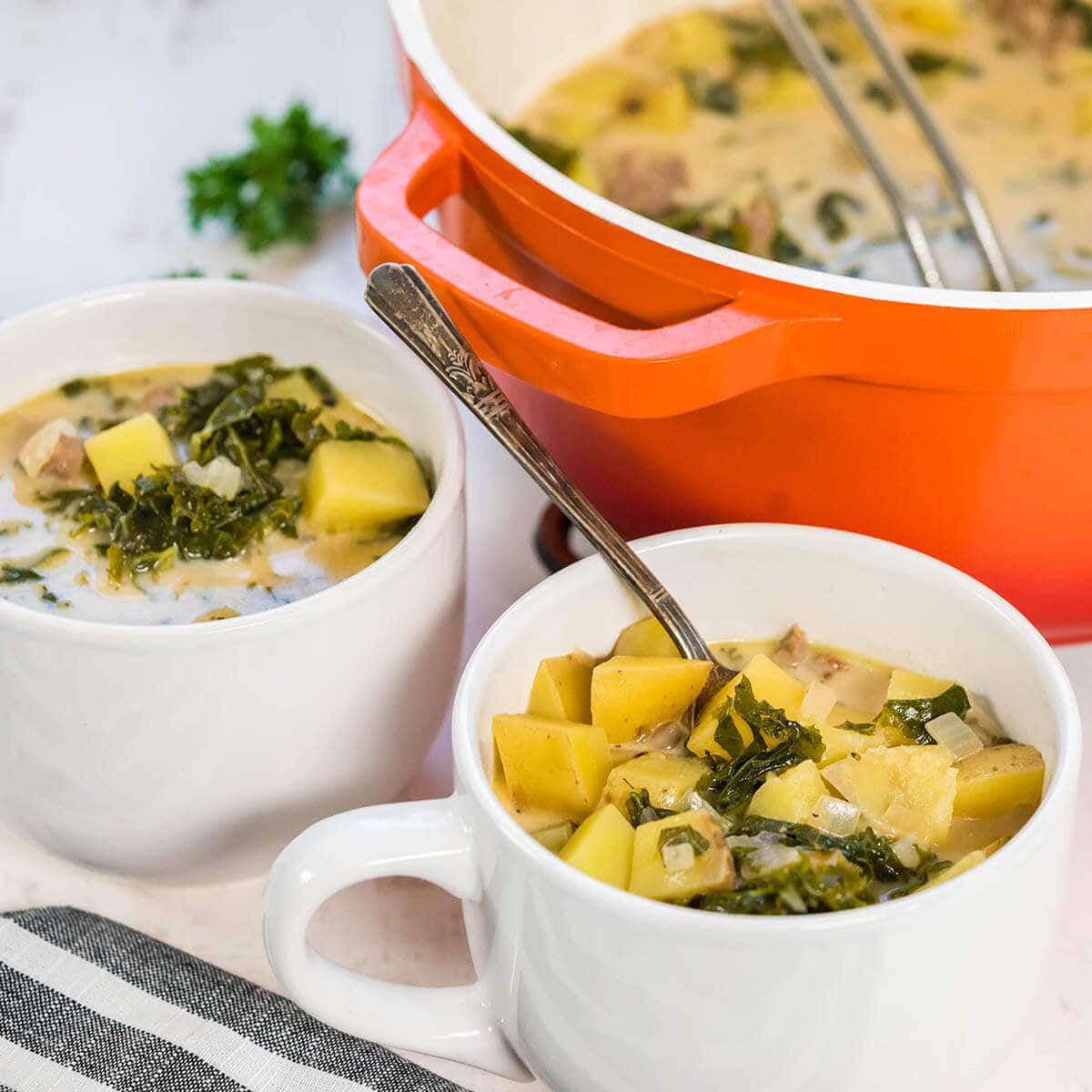 White bowls filled with Zuppa Toscana Soup Recipe.