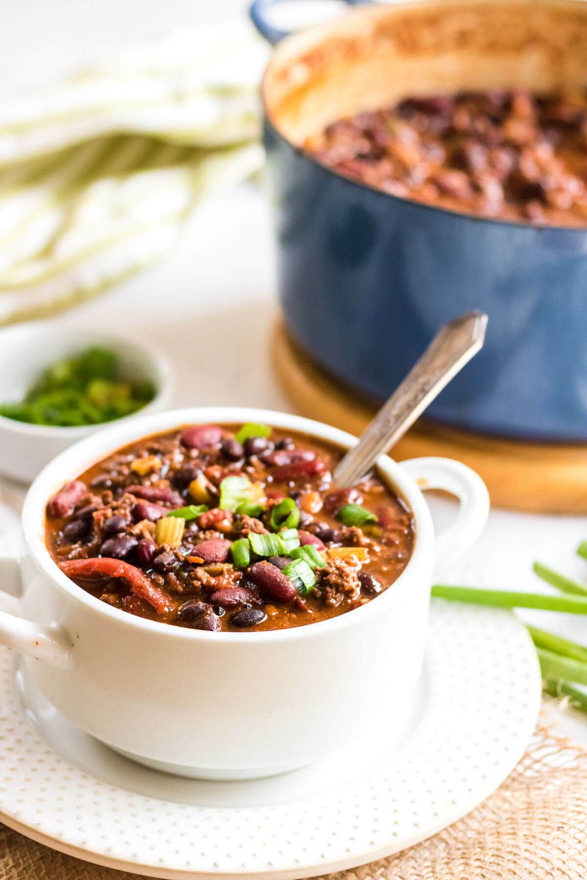A serving of chili fills a white bowl.