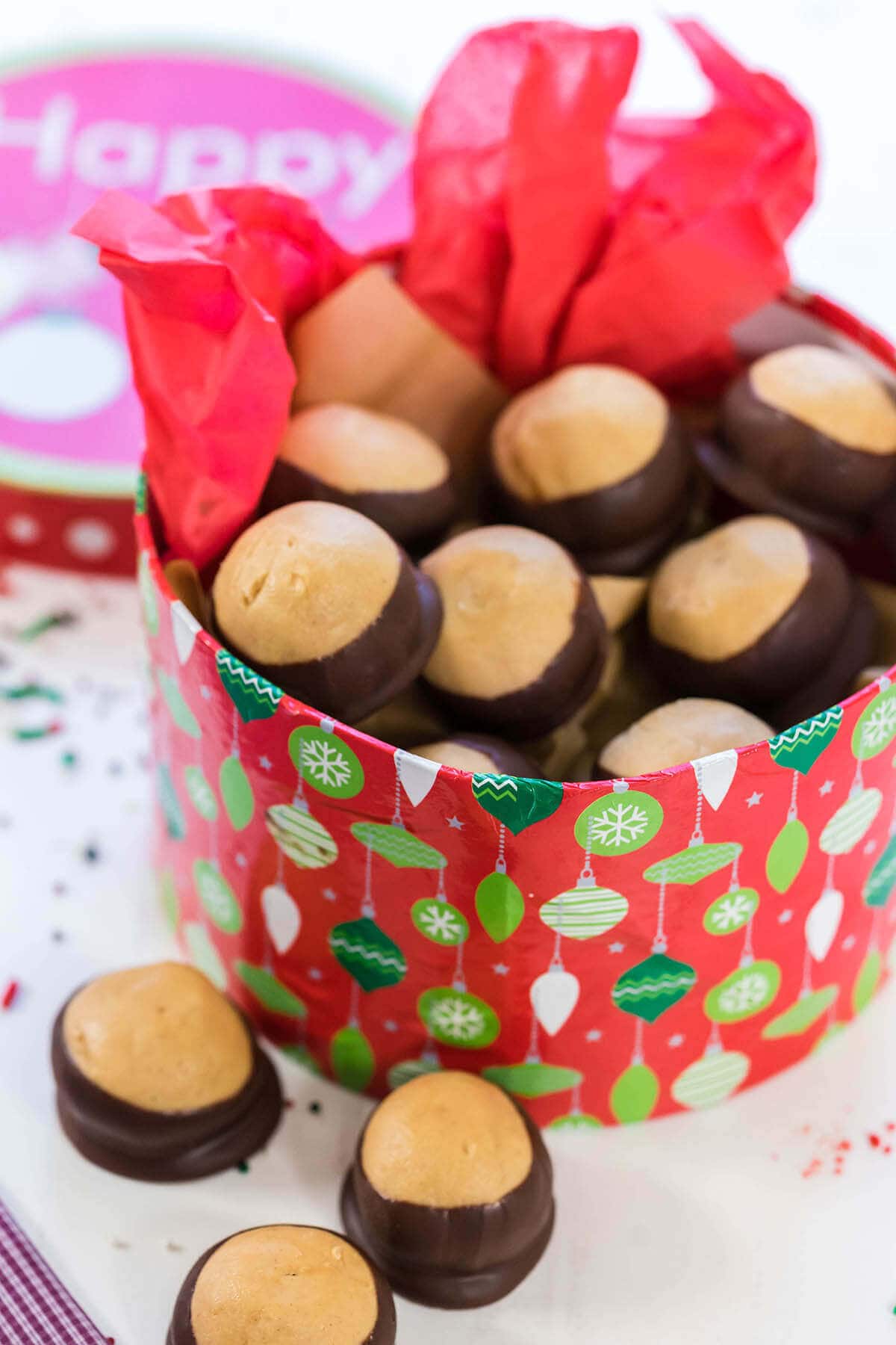 A red holiday box packed with homemade buckeye candy.