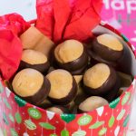 Homemade Buckeye Candy in pretty red container for gifting.